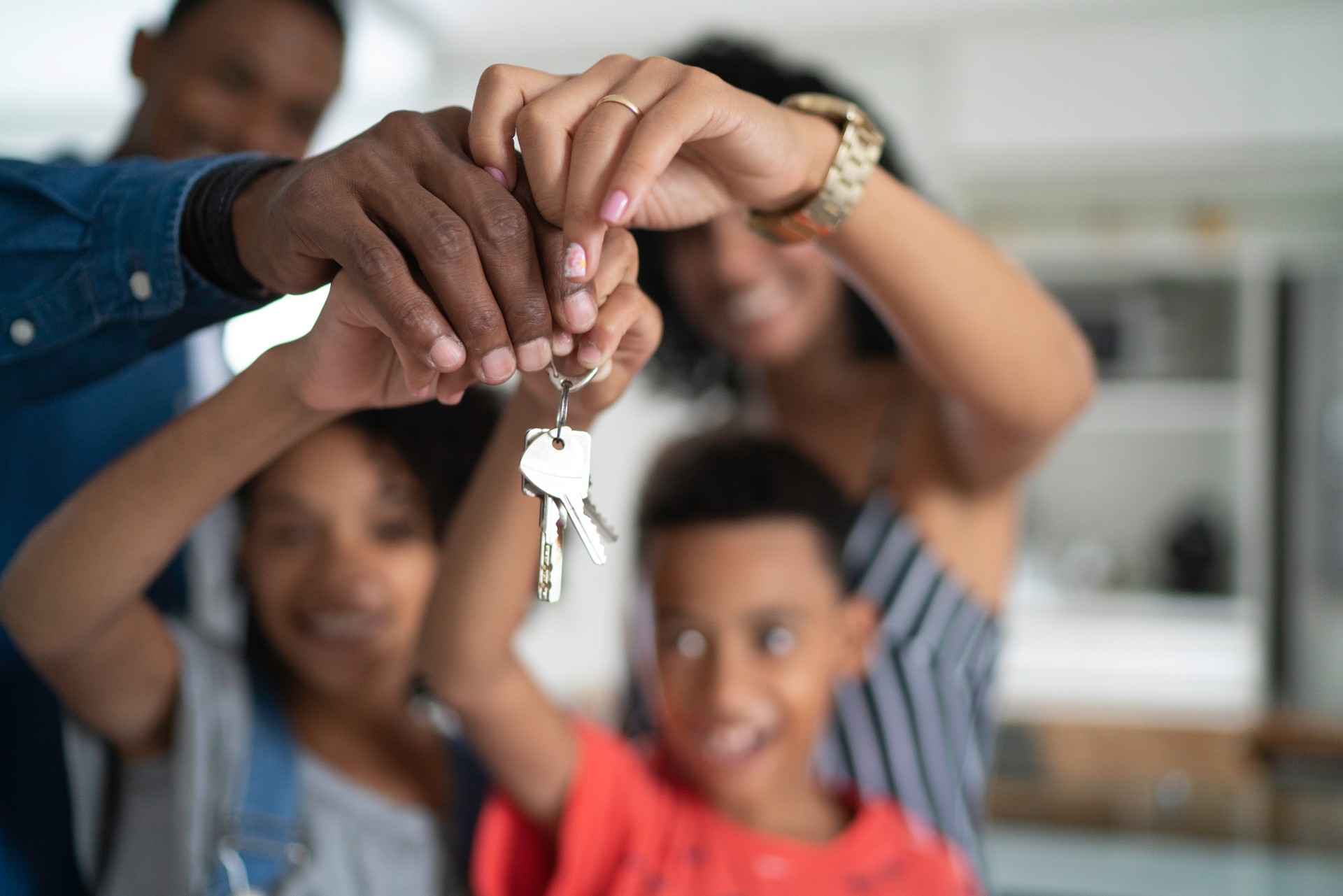 Latin family holding the keys of their new house